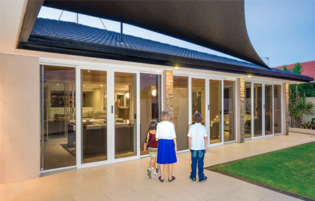 A family in their backyard, an elegant My Security Door installation welcoming them inside.