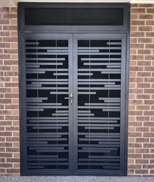 Modern aluminium security door on red brick house